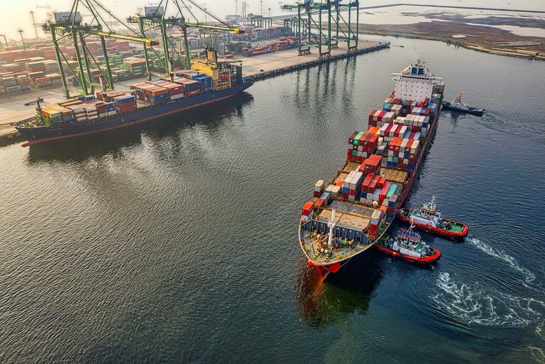 Red and blue cargo ship on the water (illustrative image)