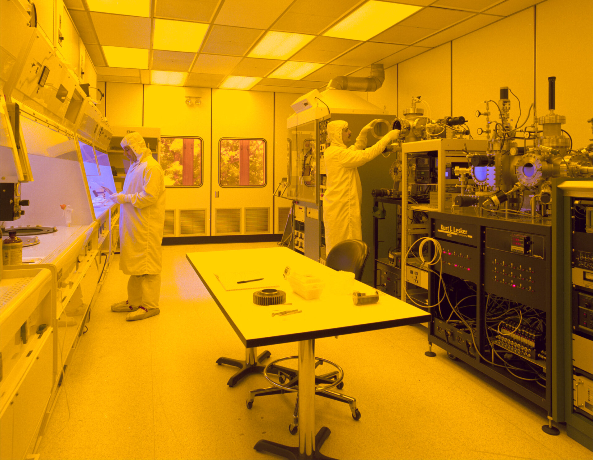 Engineers working inside a semiconductor cleanroom
