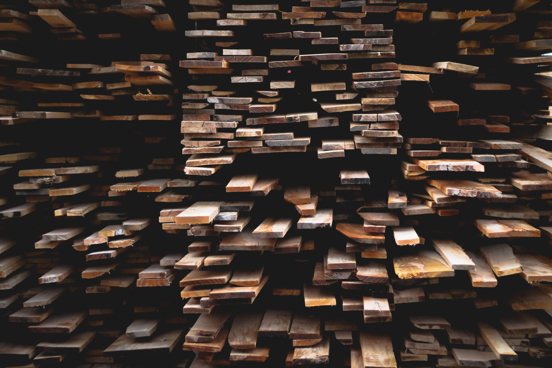Stacked softwood lumber planks at a construction supply site